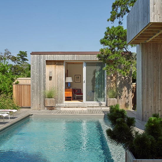 A restoration and renovation of a landmark modernist Fire Island house includes a new guest house, pool, exterior stair, entry pavilion, and landscaping. 